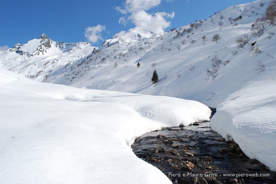 20 Il torrente Varrone tra la neve dell'Alpe.jpg